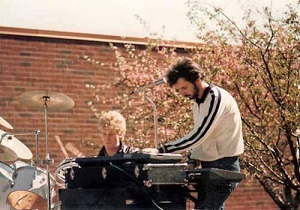 Bryan and EJ playing 'In The Cage' at the rooftop concert in May 1986